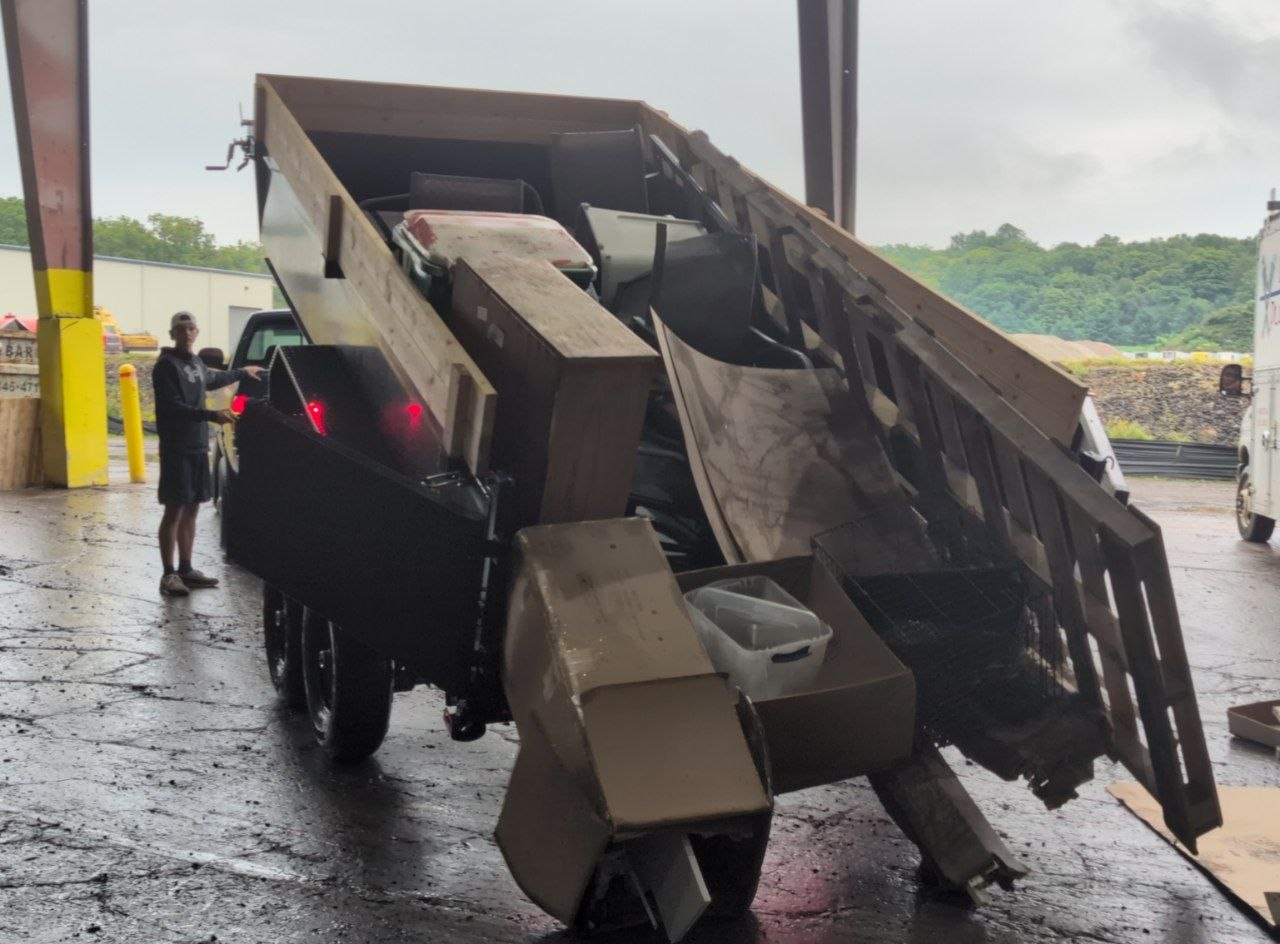 Dump trailer unloading debris at a disposal facility